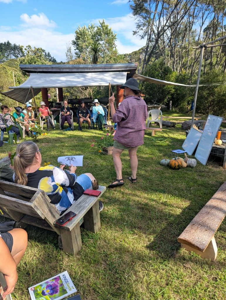 group at seed saving workshop, sitting in circle outdoors